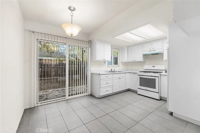 a kitchen with stainless steel appliances a stove sink and cabinets