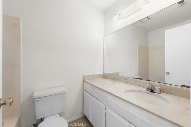 a view of a backyard with a large tree and wooden fence