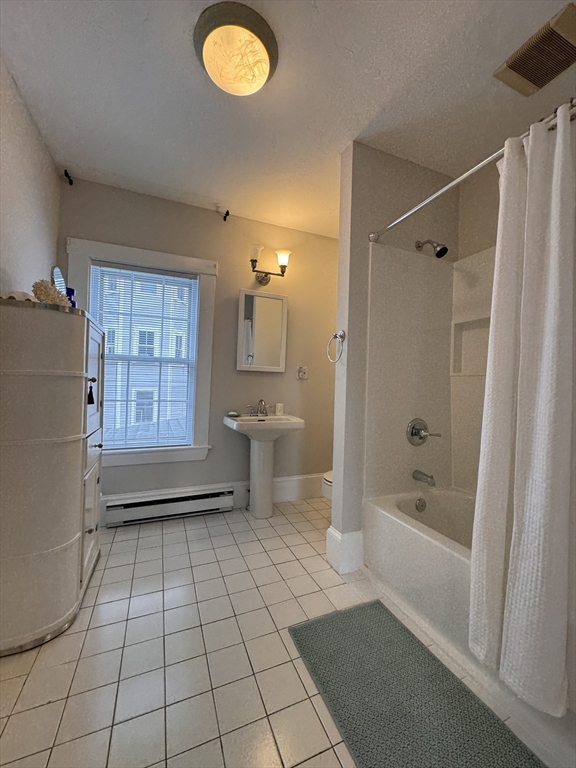 68 Cottage Street, Unit 68 Newton, MA 02464 - Photo 15 of 16 a bathroom with a sink a toilet and shower