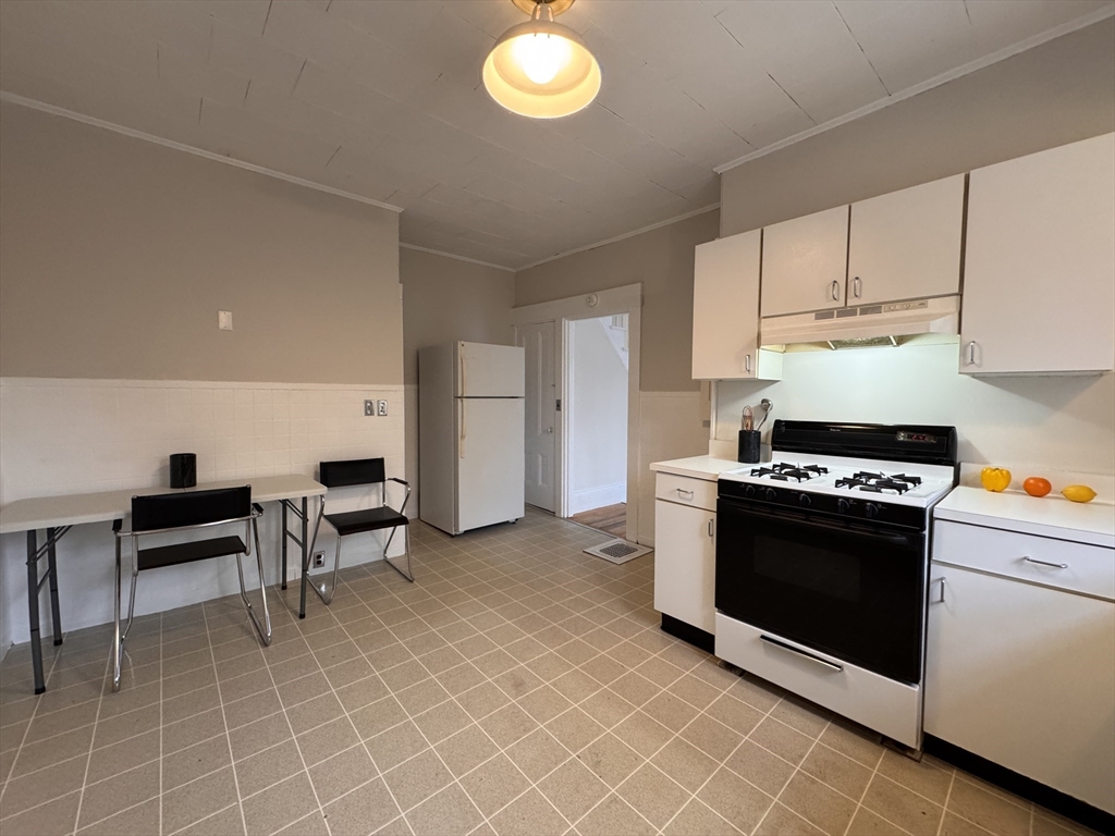 68 Cottage Street, Unit 68 Newton, MA 02464 - Photo 6 of 16 a kitchen with cabinets and steel appliances