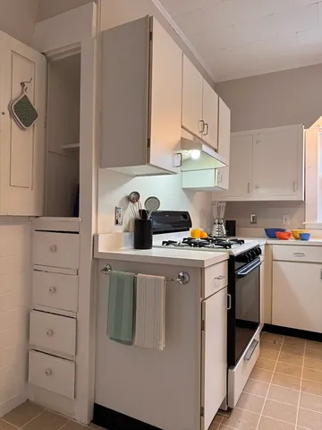 a kitchen with a stove and a refrigerator