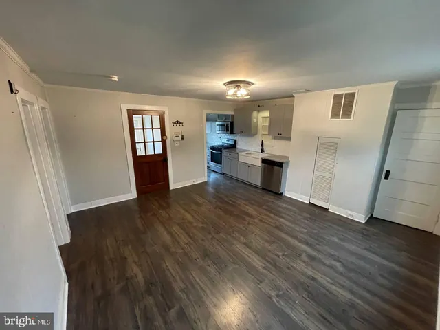 a view of a kitchen with a sink and a refrigerator
