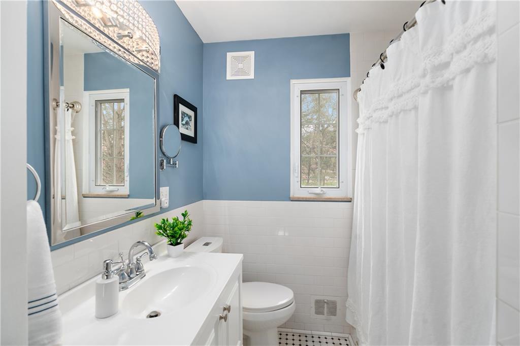 349 Backbone Road Sewickley, PA 15143 - Photo 18 of 25 a bathroom with a sink a toilet and shower curtain
