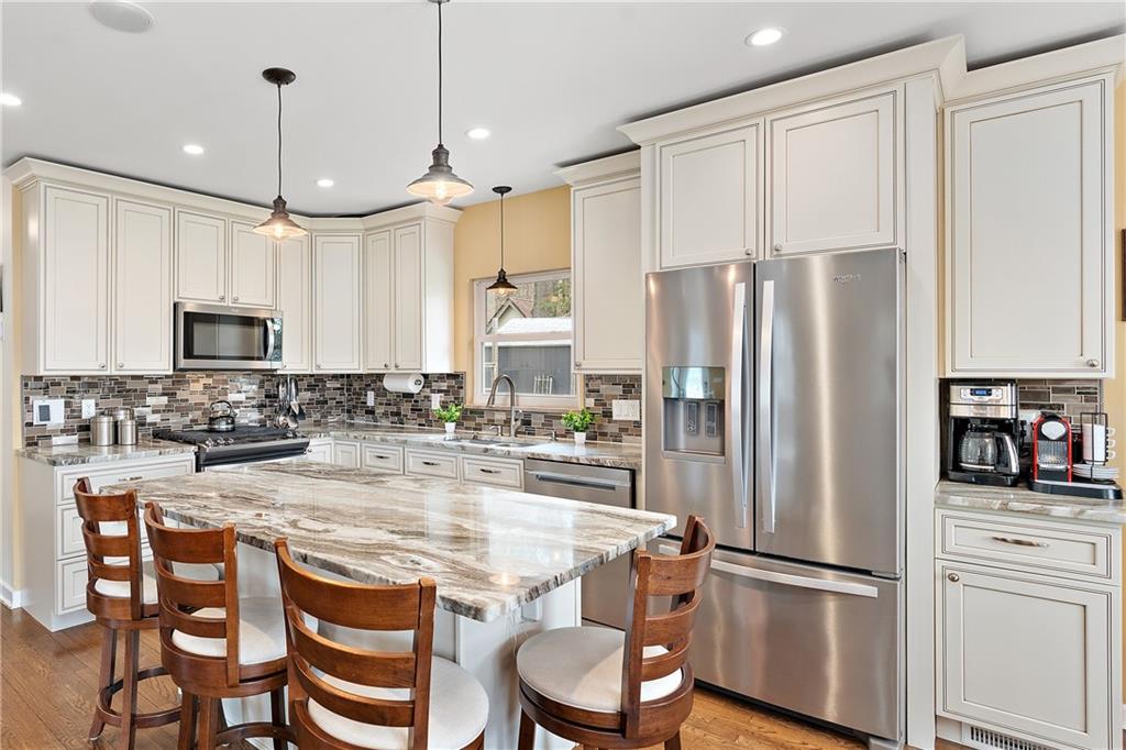 349 Backbone Road Sewickley, PA 15143 - Photo 8 of 25 a kitchen with stainless steel appliances granite countertop a refrigerator and a stove top oven