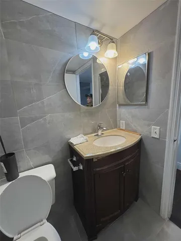 a bathroom with a sink a mirror and a toilet