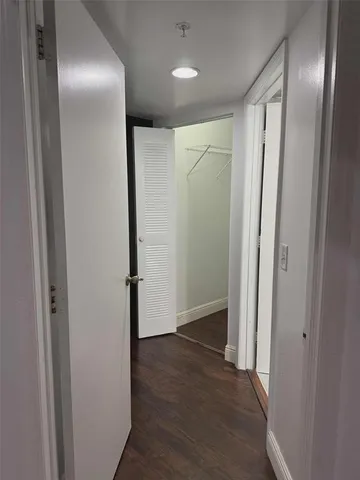 a kitchen with a sink cabinets and wooden floor