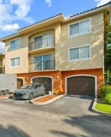 a front view of a house with a yard and a garage