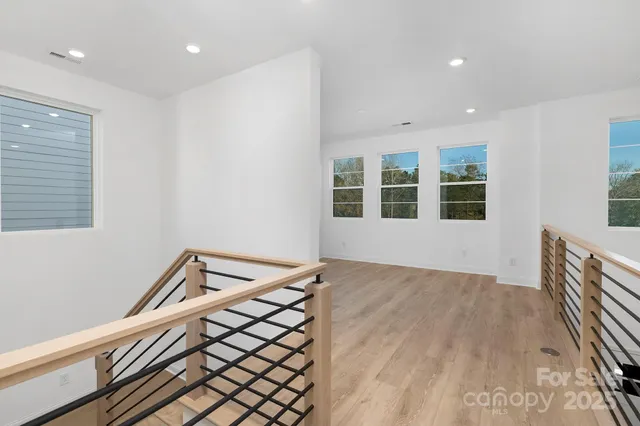 a view of a room with wooden floor and staircase