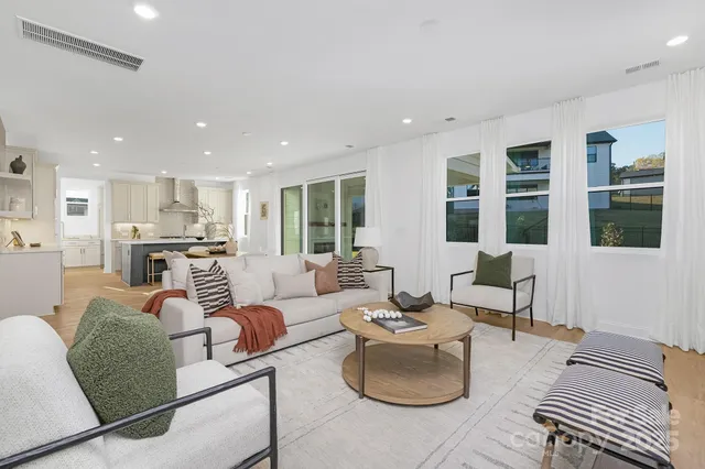 a living room with furniture and kitchen view