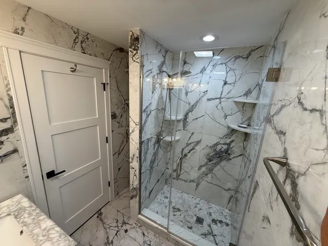 a bathroom with a shower and a sink