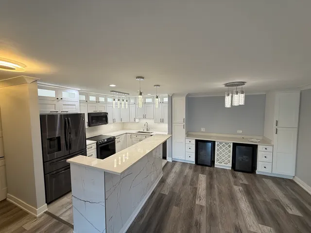a large white kitchen with a stove a sink dishwasher and a refrigerator