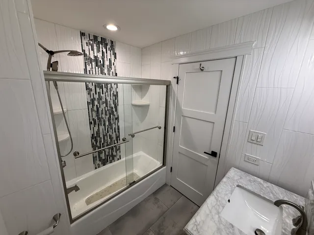 a bathroom with a sink and shower