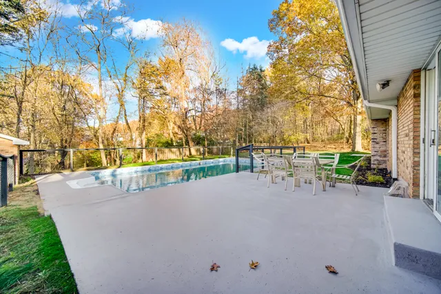 a view of swimming pool with outdoor seating and plants