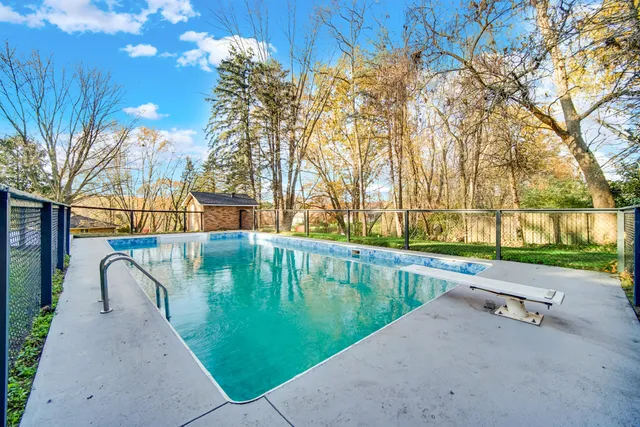a swimming pool with outdoor seating and yard