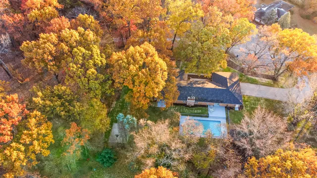 a house view with a tree in front of it