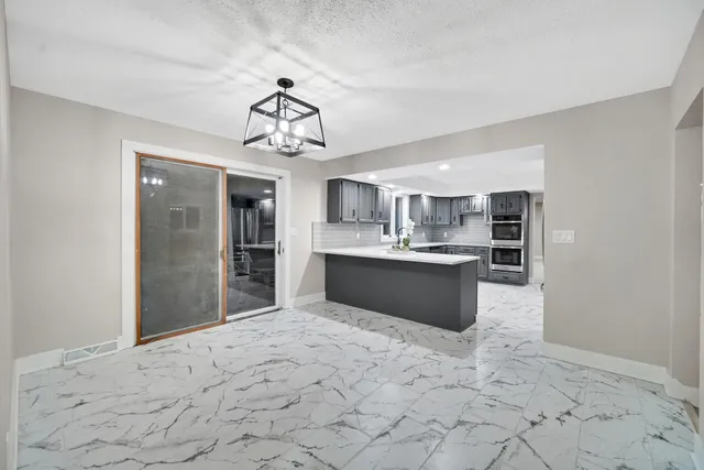 a view of a kitchen with a sink and cabinets