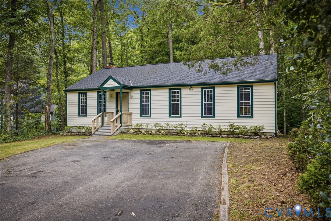 Exterior featuring siding, dark-shingle roofing, a