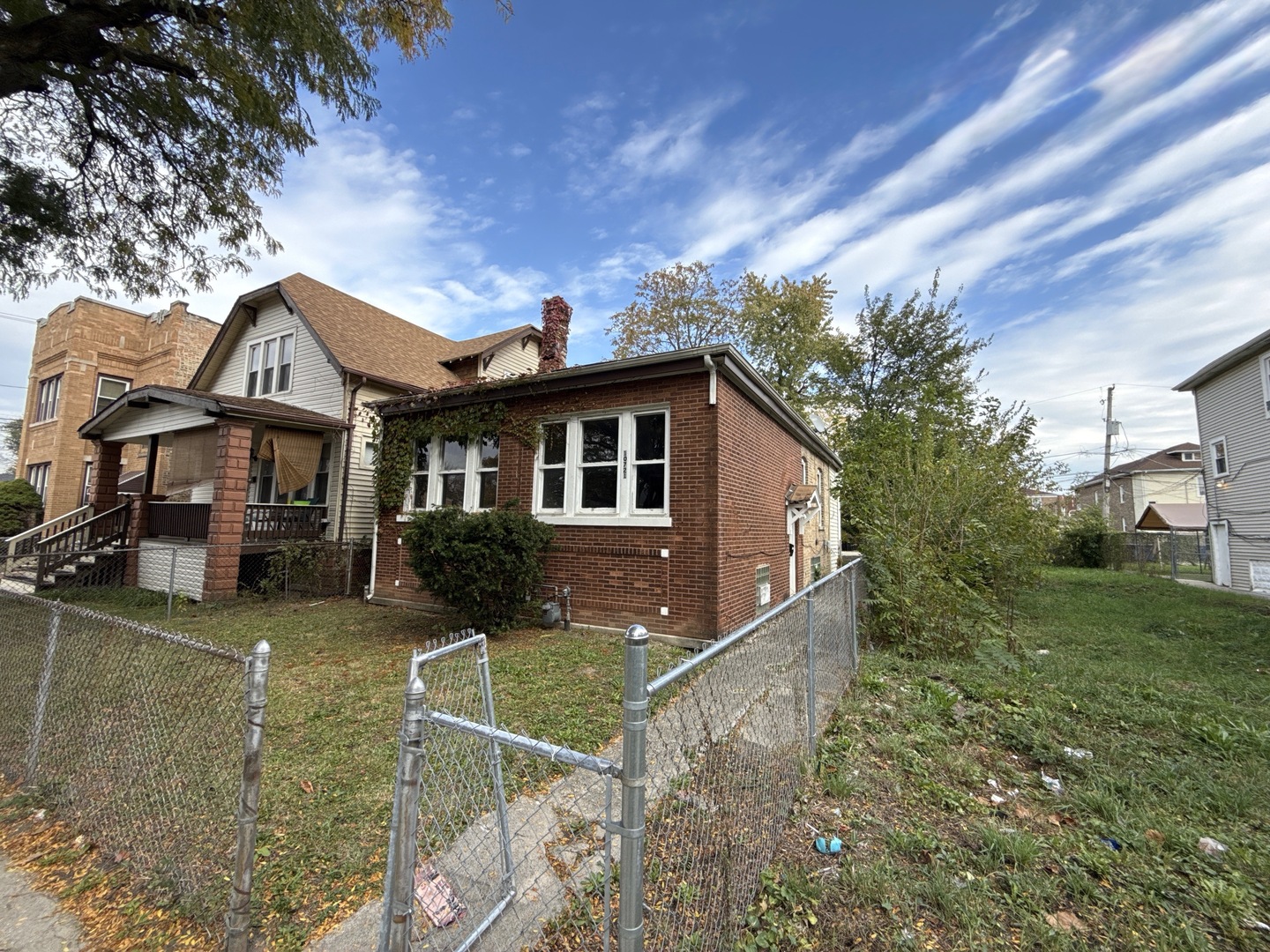 10721 South Prairie Avenue Chicago, IL 60628 - Photo 2 of 14 a front view of a house with yard and green space