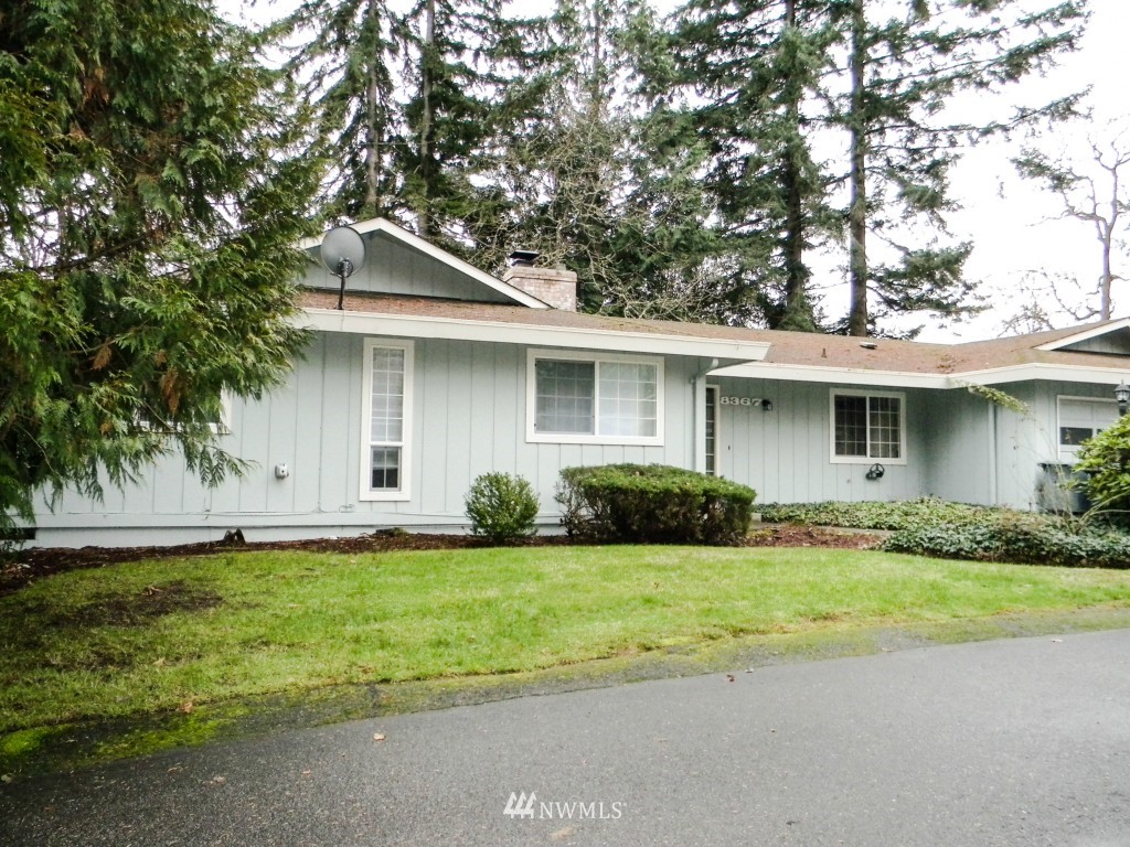 8327-8375 Phillips Road Southwest Lakewood, WA 98498 - Photo 14 of 23 a front view of a house with a yard and garage