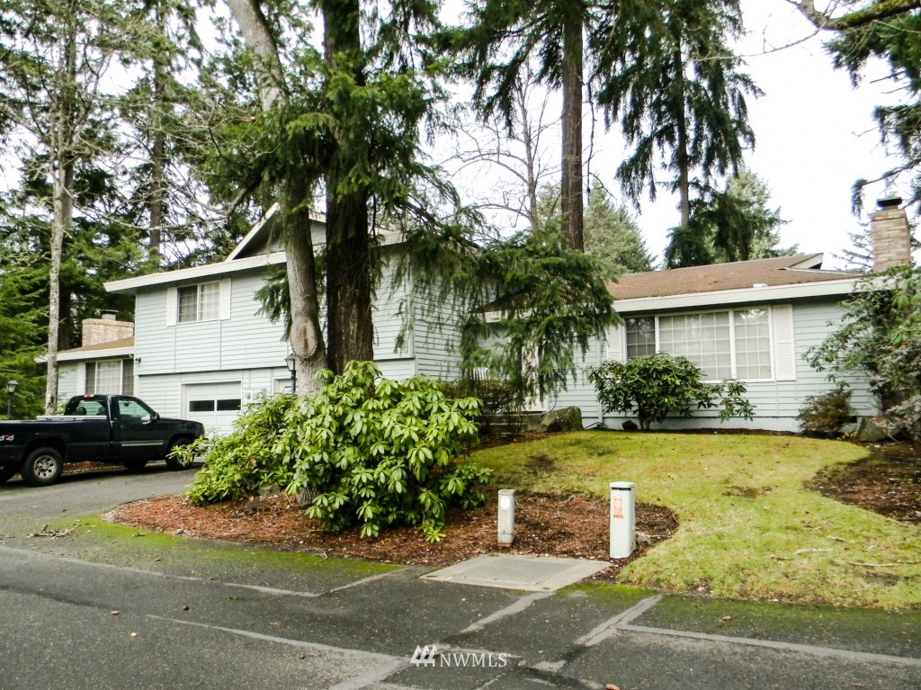8327-8375 Phillips Road Southwest Lakewood, WA 98498 - Photo 3 of 23 a front view of a house with garden