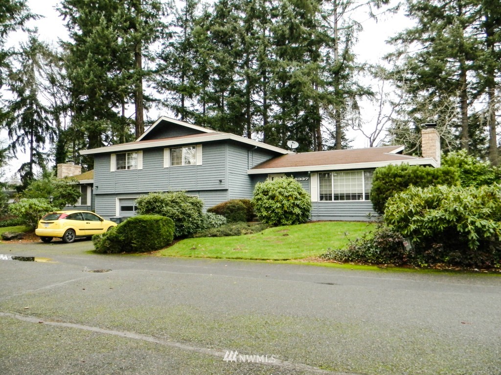 8327-8375 Phillips Road Southwest Lakewood, WA 98498 - Photo 5 of 23 a front view of a house with a garden