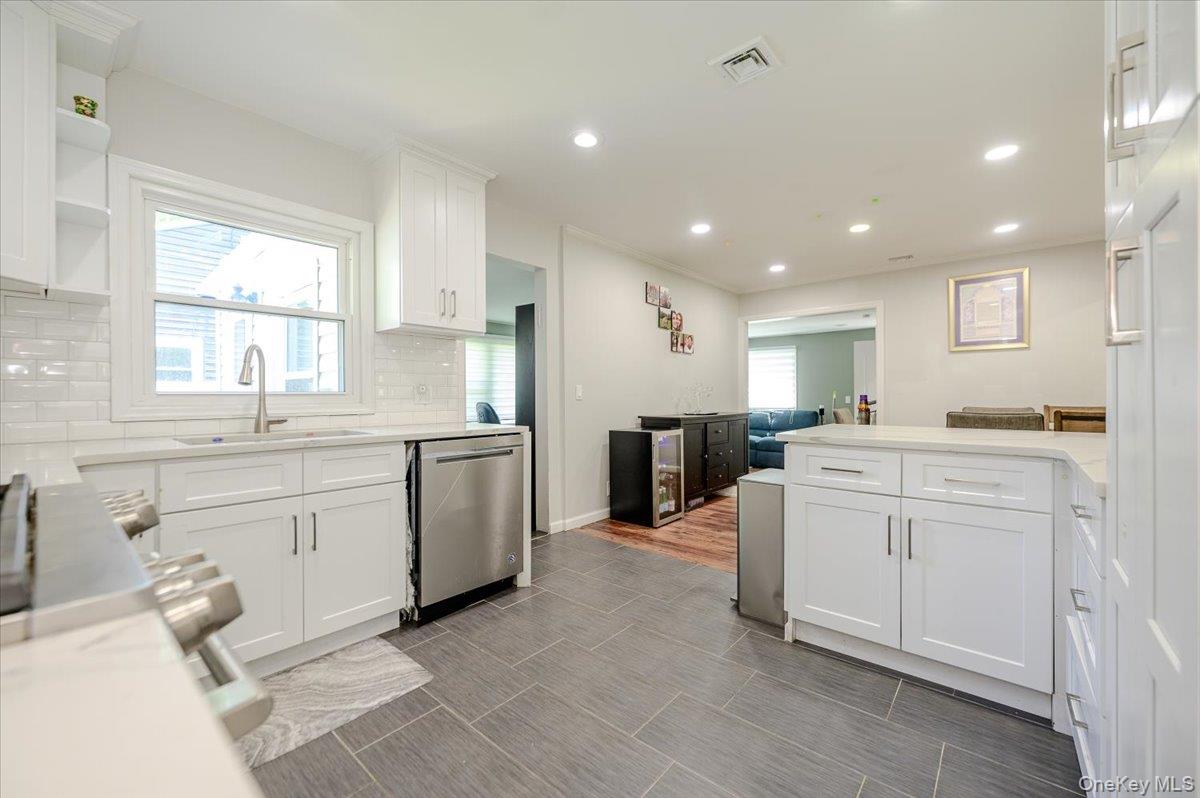 534 Allen Road Woodmere, NY 11598 - Photo 10 of 35 a kitchen with white cabinets and sink