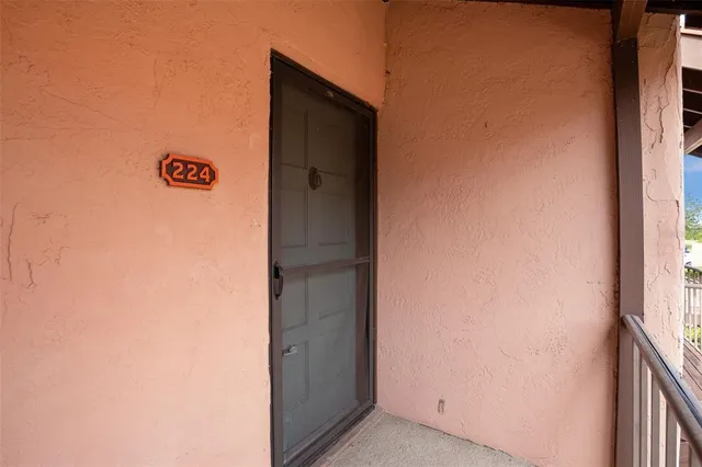a view of wooden floor and windows in a room