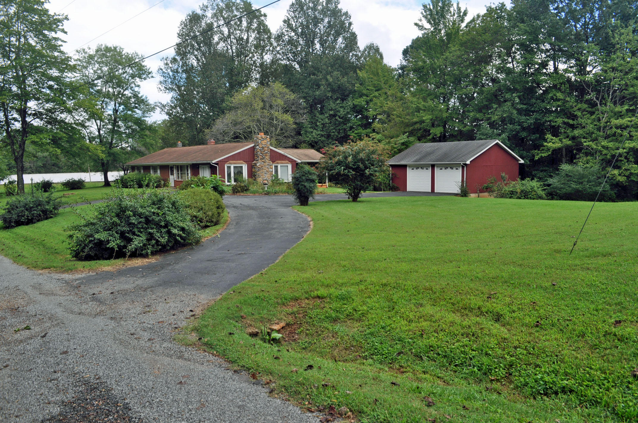 124 Pony Ridge Road Bassett, VA 24055 - Photo 2 of 41 a front view of a house with a garden