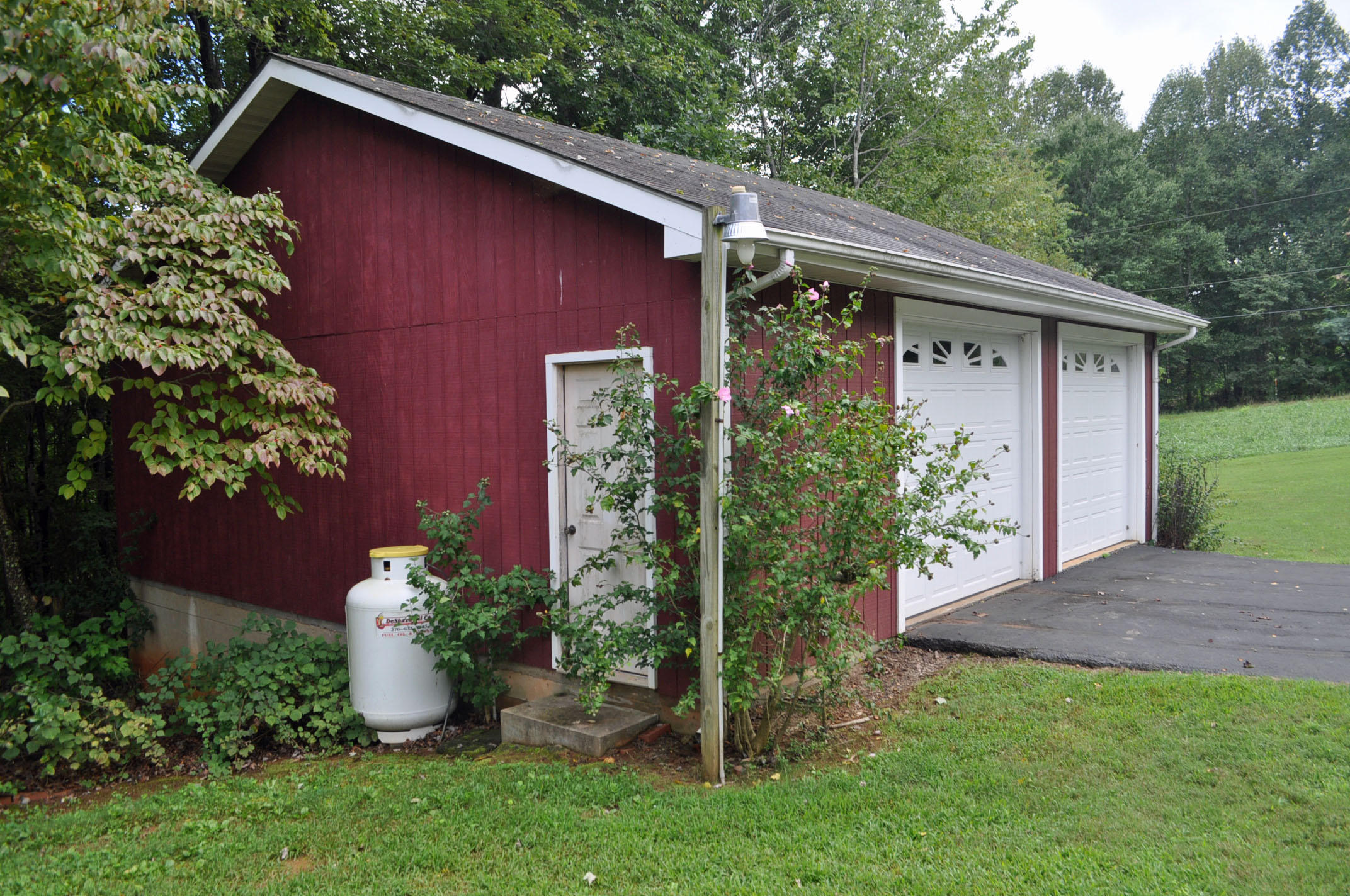 124 Pony Ridge Road Bassett, VA 24055 - Photo 12 of 41 a view of a wooden house with a yard potted plants and a table
