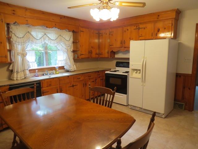 124 Pony Ridge Road Bassett, VA 24055 - Photo 23 of 41 a kitchen with stainless steel appliances a dining table chairs and a refrigerator