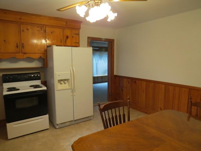 124 Pony Ridge Road Bassett, VA 24055 - Photo 24 of 41 a bedroom with a bed and a chandelier