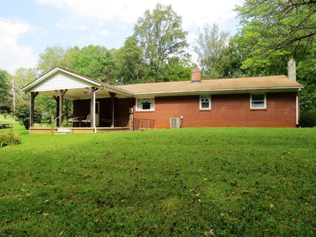 124 Pony Ridge Road Bassett, VA 24055 - Photo 39 of 41 a front view of a house with a yard table and chairs