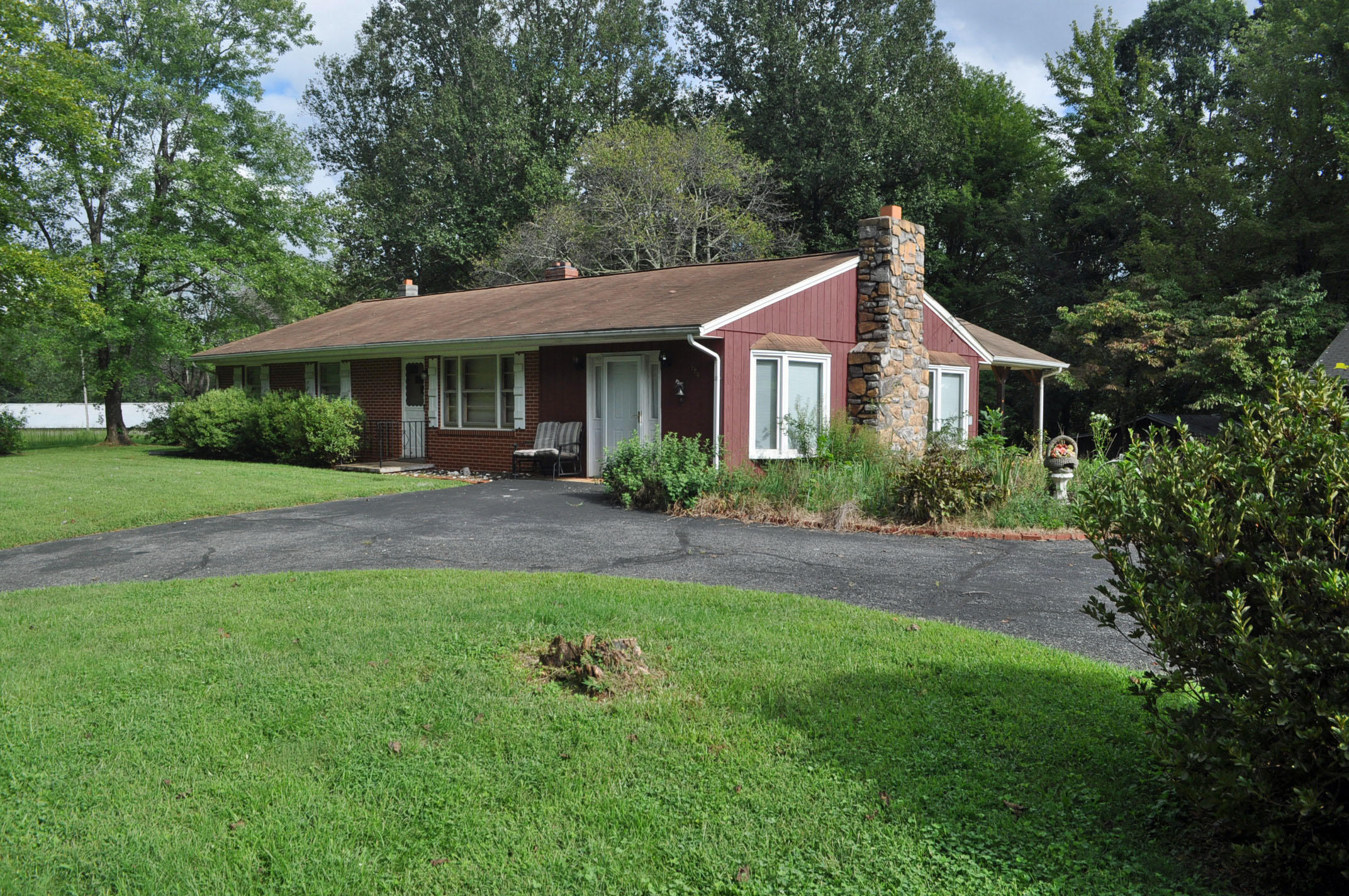 124 Pony Ridge Road Bassett, VA 24055 - Photo 9 of 41 a front view of a house with a garden and trees