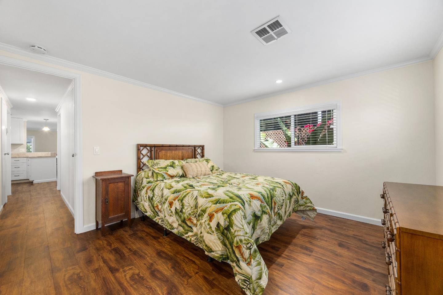 4160 Jade Street, Unit 69 Capitola, CA 95010 - Photo 11 of 27 a bedroom with a bed and wooden floor