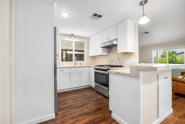 a kitchen with a stove a sink and a refrigerator