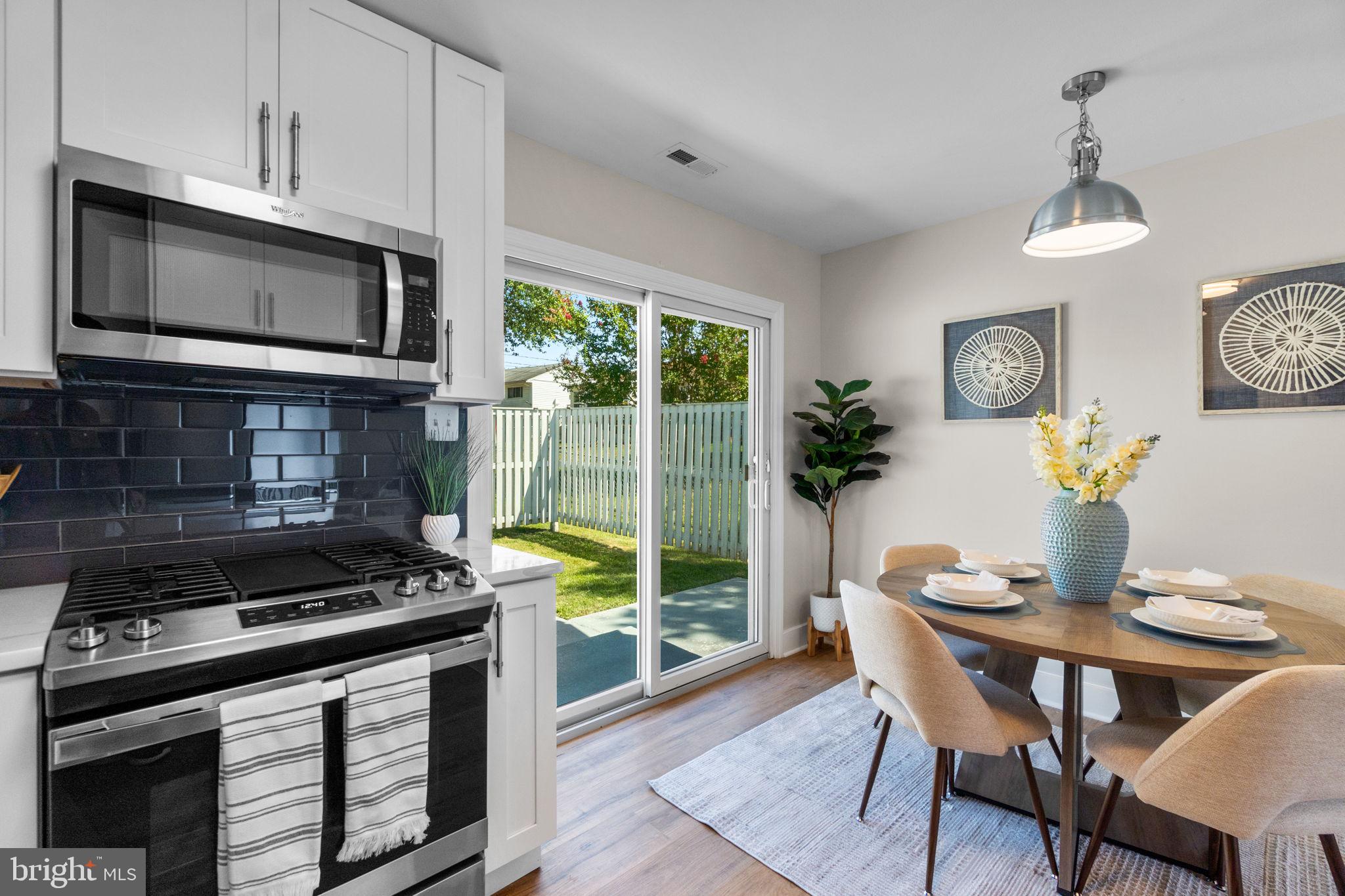 1012 Dunholme Road Reisterstown, MD 21136 - Photo 12 of 30 a kitchen with a stove a microwave and a dining table