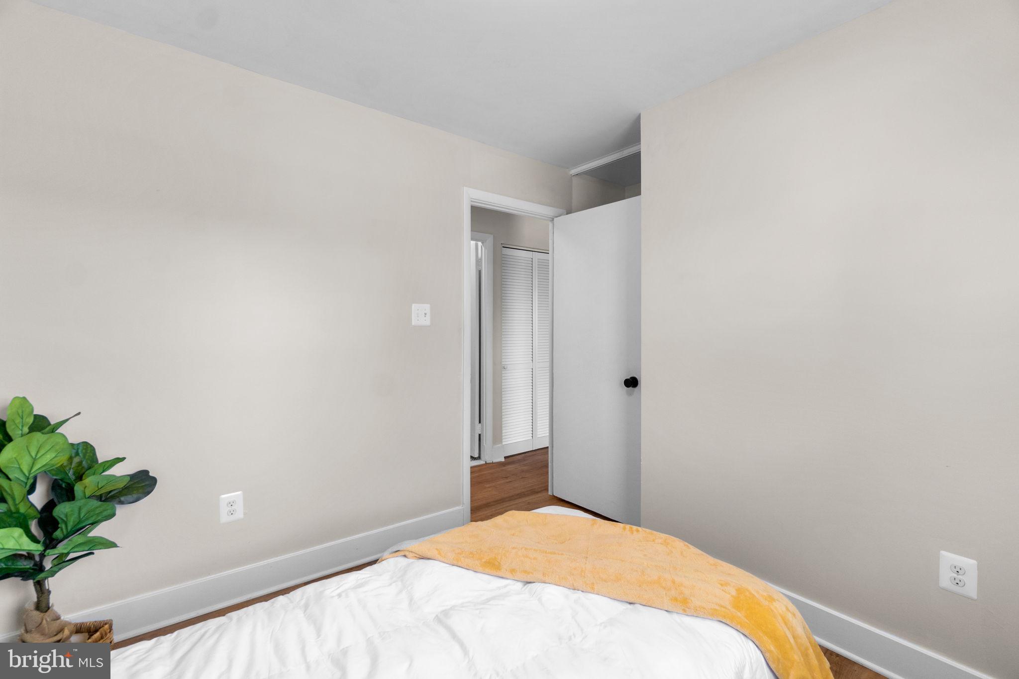 1012 Dunholme Road Reisterstown, MD 21136 - Photo 22 of 30 a bedroom with a bed and a potted plant