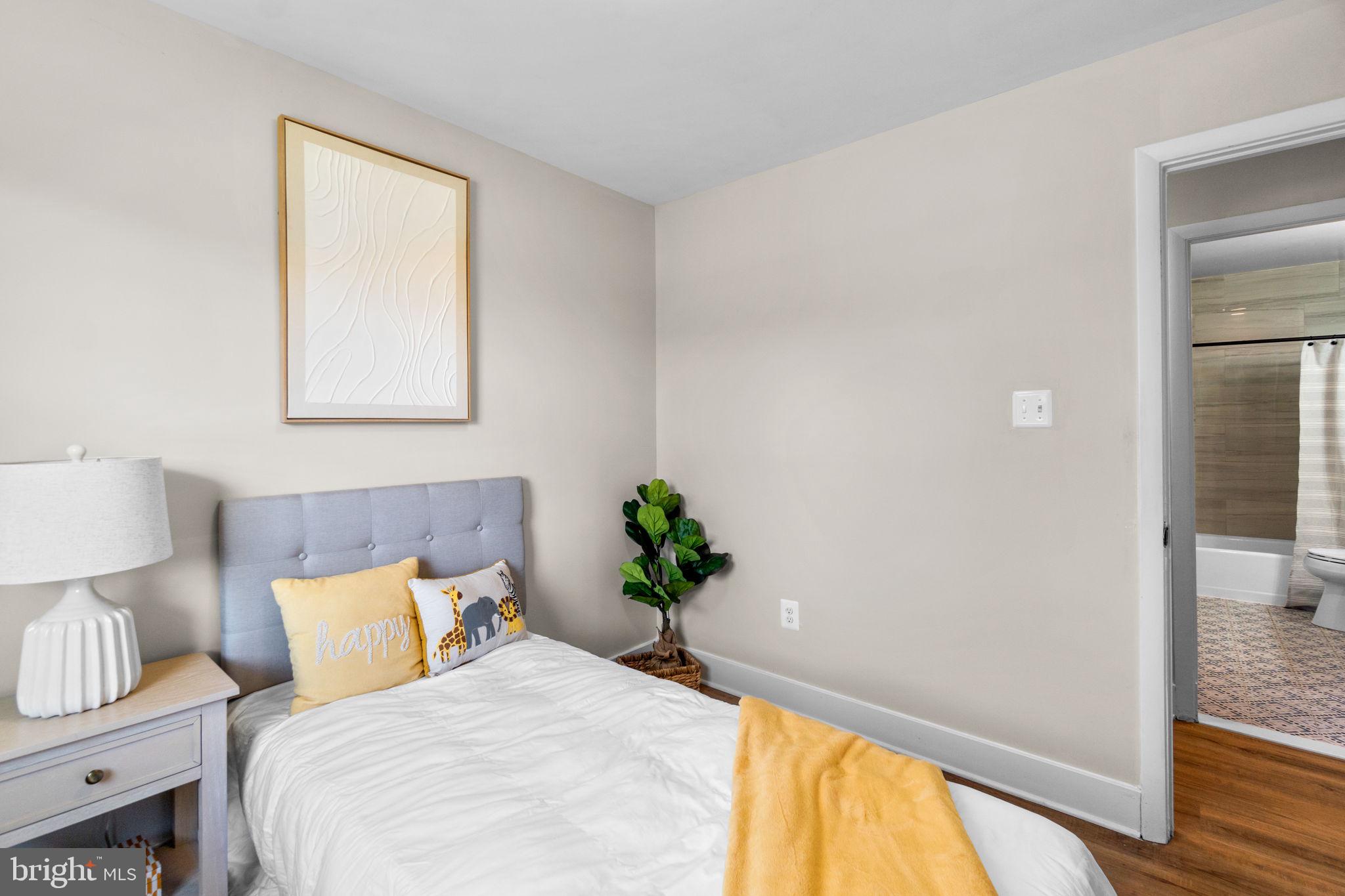 1012 Dunholme Road Reisterstown, MD 21136 - Photo 23 of 30 a bedroom with a bed and a potted plant