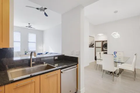 a kitchen with a sink and chairs