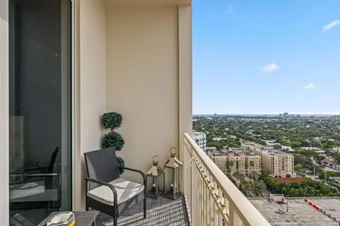 a balcony with wooden floor and outdoor seating