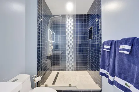 a bedroom with bed and a chandelier