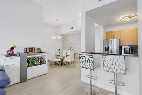 a living room with furniture and a book shelf