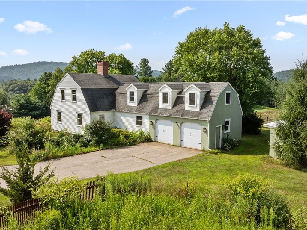 439 Lower Road Hardwick, MA 01031 - Photo 1 of 41 a front view of a house with a yard and garage