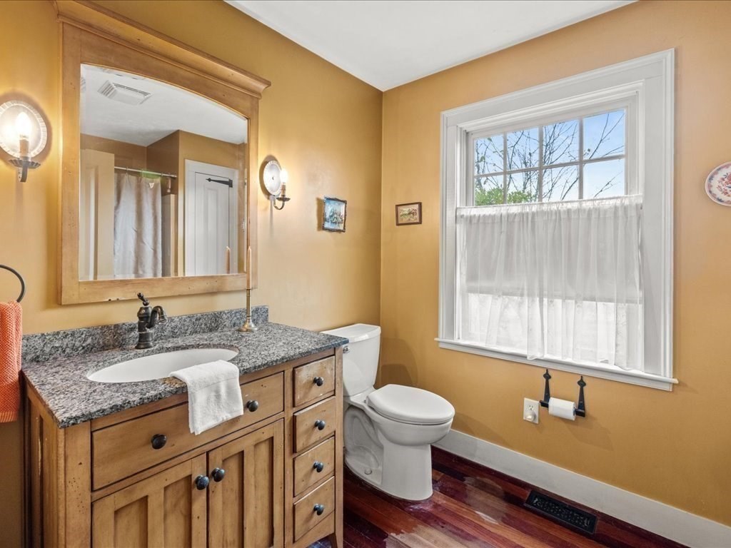 439 Lower Road Hardwick, MA 01031 - Photo 16 of 41 a bathroom with a granite countertop toilet sink and mirror