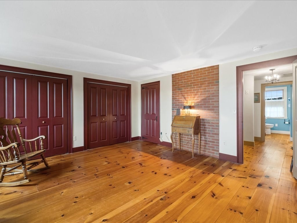 439 Lower Road Hardwick, MA 01031 - Photo 18 of 41 a view of a bedroom with wooden floor and windows