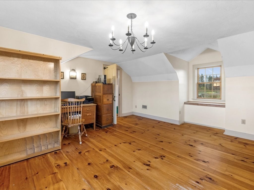 439 Lower Road Hardwick, MA 01031 - Photo 20 of 41 a bedroom with furniture and a chandelier