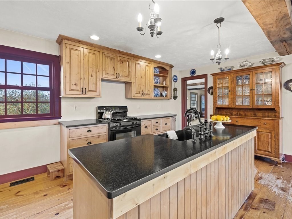 439 Lower Road Hardwick, MA 01031 - Photo 8 of 41 a kitchen with stove cabinets and chandelier