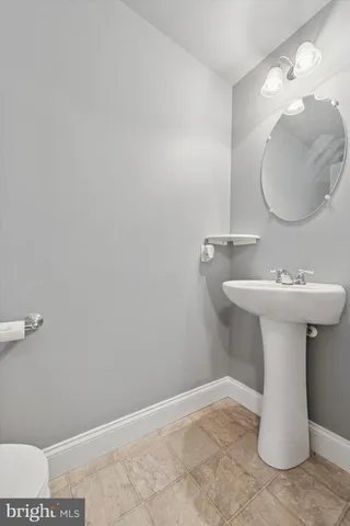 a bathroom with a sink toilet and mirror
