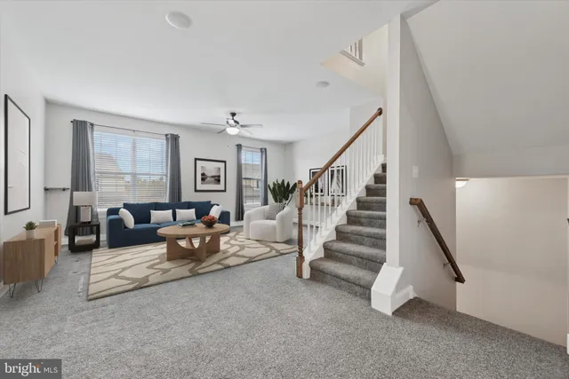 a living room with furniture and stairs