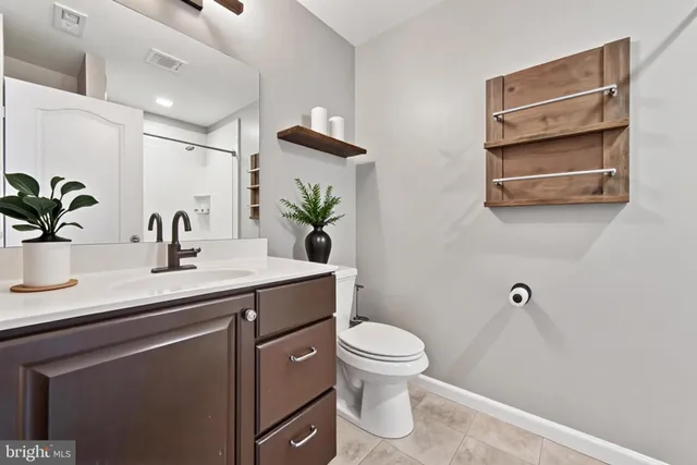 a bathroom with a toilet a sink and mirror
